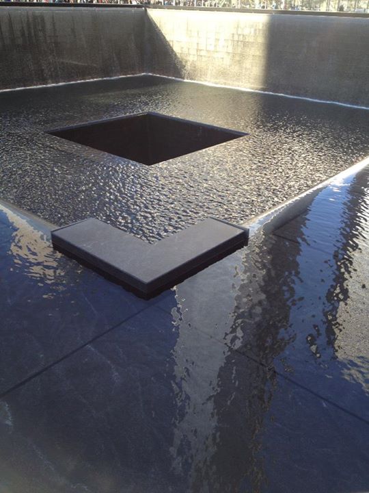 World Trade Center Memorial. One of the tower pools with the new WTC building in the reflection.